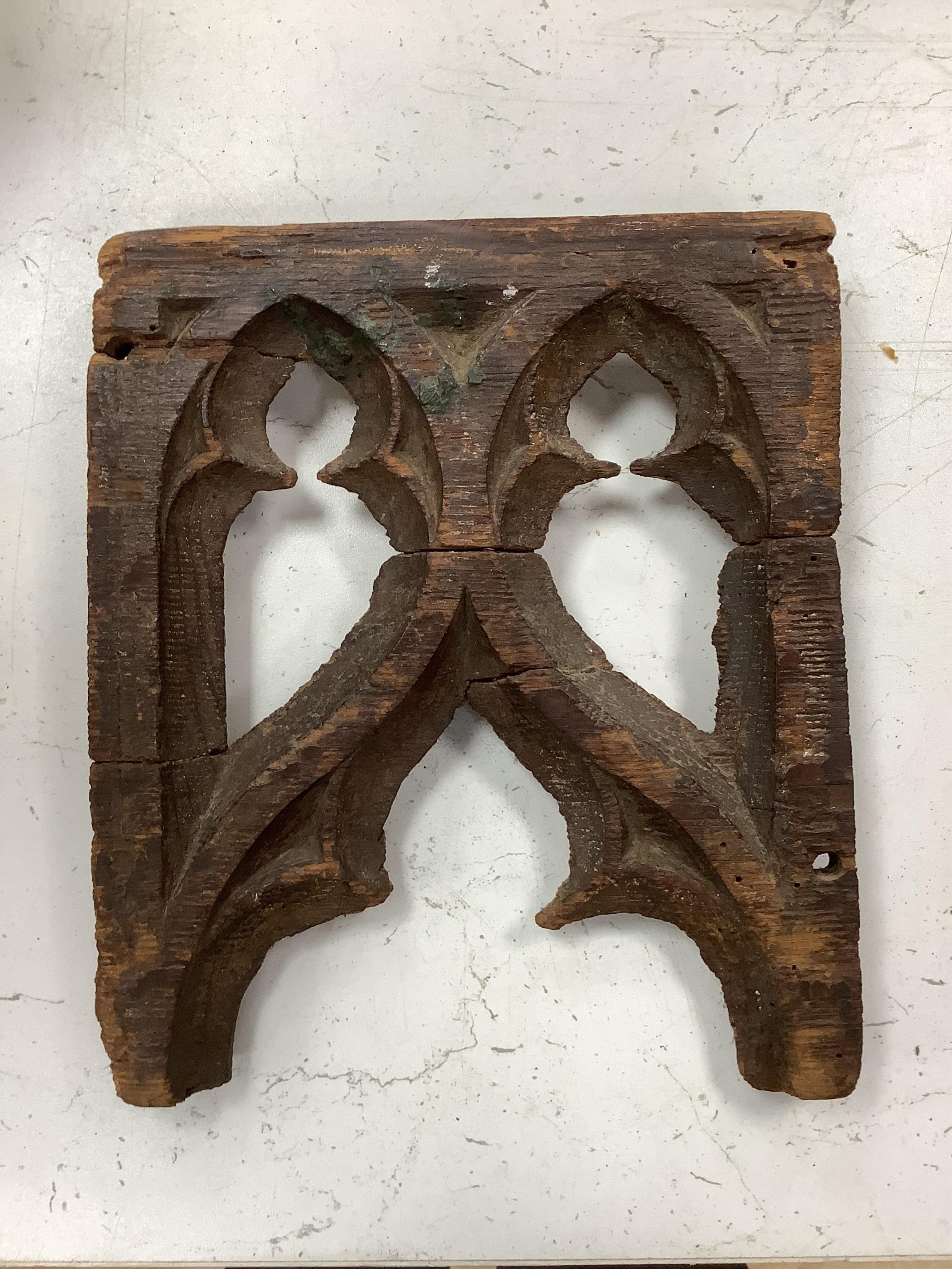 A 19th century leather binding for a book, 35cm high x 33.5cm wide, two carved gothic panels and a carved figure